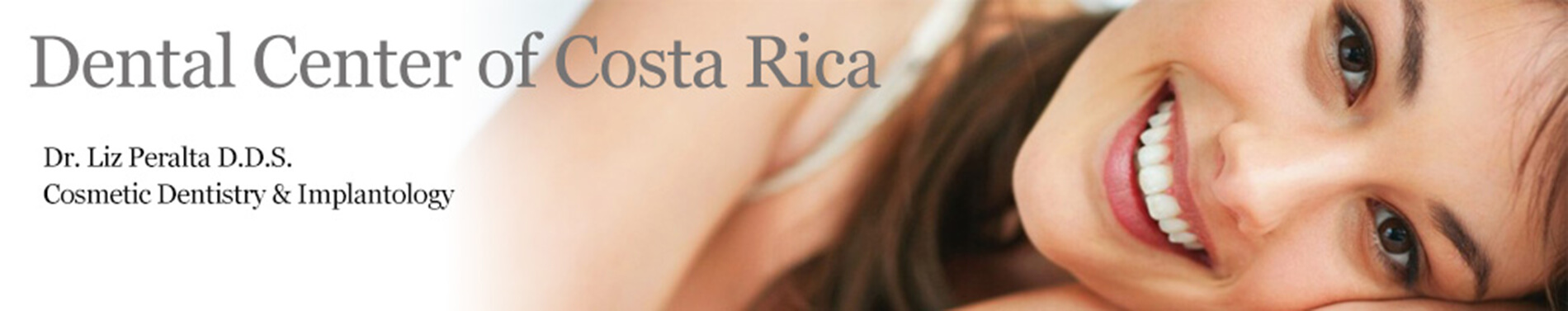 Banner featuring a portrait picture of a smiling woman with long brown hair happy with her Implantology procedure she had with the Dental Center of Costa Rica, San Jose, Costa Rica.